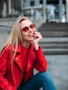 Nice girl in trendy red leather jacket looking at camera Royalty Free Stock Photo