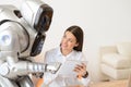 Nice girl using tablet with robot Royalty Free Stock Photo