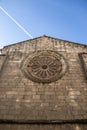 Nice gothic rose window on a stone wall of a church in sunny day. Galician city of Lugo, Spain Royalty Free Stock Photo