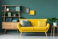 Nice green loveseat sofa with yellow pillows. Wooden bookcase near teal wall. Scandinavian interior design of modern room