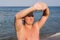 Nice guy squinting in the sun on beach Royalty Free Stock Photo