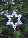 Handmade white shining star hanging on Christmas tree Royalty Free Stock Photo