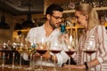 Nice handsome man looking at the glass with blue wine Royalty Free Stock Photo
