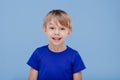 Nice hapy child looks at the camera dressed in blue T-shirt,