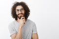 Nice idea, you intrigued me. Portrait of interested smart handsome adult man with beard and curly hair in trendy glasses Royalty Free Stock Photo