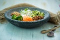 Nice image of a fresh salad on a wooden table with wooden spoons.