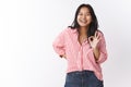 Nice joke. Portrait of amused gorgeous malasian female in striped blouse having fun laughing out loud from joy hearing Royalty Free Stock Photo