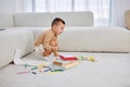 nice kid boy draws on floor in bright living room. happy child draws with pencils. Royalty Free Stock Photo