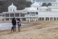 Nice landscape with a couple walking with their dog on the Caleta beach, in Cadiz, Spain Royalty Free Stock Photo