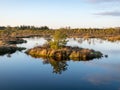 Nice landscape with evening and sunset over the bog lake, crystal clear lake and peat island in the lake and bog vegetation, bog Royalty Free Stock Photo