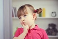 A nice little girl dreams in her room Royalty Free Stock Photo