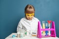 Nice little girl looking at flask and science equipment Royalty Free Stock Photo