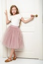 A little girl is standing by the door. Royalty Free Stock Photo