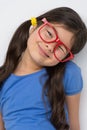 Nice little girl wearing red glasses.
