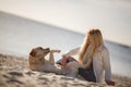 Close up portrait of beautiful long haired girl with her Labrador Retriever dog on the beach Royalty Free Stock Photo