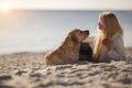 Close up portrait of beautiful long haired girl with her Labrador Retriever dog on the beach Royalty Free Stock Photo