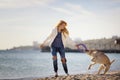 Close up portrait of beautiful long haired girl playing with her Labrador Retriever dog on the beach Royalty Free Stock Photo