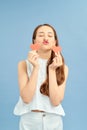 Nice-looking attractive lovely girl holding in hands two small little heart sending you hot kiss isolated over blue background Royalty Free Stock Photo