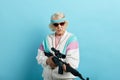 Nice looking grandmother- FBI agent aiming with a rifle, ready to shoot, poster.