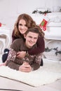 Nice love couple on carpet. Woman and man celebrating Christmas