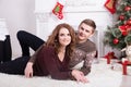 Nice love couple on carpet. Woman and man celebrating Christmas