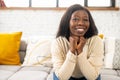 Nice lovely African-American woman sitting on the comfortable sofa in cozy living room, multiracial lady resting at home Royalty Free Stock Photo