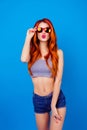 Nice Lovely Carefree Girl Pouting Pink Lips And Holding Sunglasses. Pretty Girlfriend With Curly Long Red Hair And