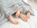 Nice loving couple lying in bed under blanket. Royalty Free Stock Photo