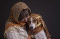 Portrait of mature Caucasian woman with lovely basenji dog both wearing headscarfs