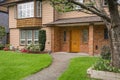 Nice main entrance of old family house with concrete pathway over front yard Royalty Free Stock Photo