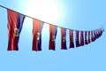 nice many Haiti flags or banners hangs diagonal on rope on blue sky background with bokeh - any holiday flag 3d illustration