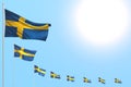 Nice many Sweden flags placed diagonal on blue sky with space for text - any occasion flag 3d illustration