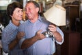 nice mature couple is shopping the old lamp in the antique store Royalty Free Stock Photo