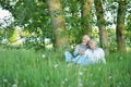 Nice mature couple sitting on green grass Royalty Free Stock Photo