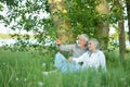 Nice mature couple sitting on green grass Royalty Free Stock Photo