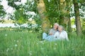 Nice mature couple sitting on green grass Royalty Free Stock Photo