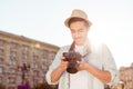 Nice memories of summer vacation! Young male tourist with a digital camera is checking the photos he took outside, with beaming s Royalty Free Stock Photo