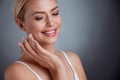 Nice middle aged woman applying face cream Royalty Free Stock Photo