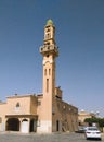 Nice minaret with windows nd balcony and small green dome at the top n Riyadh