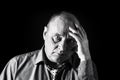 Monochrome portrait of pensive office clerk against black background