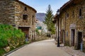 Nice narrow street of old town with stone houses and flowering trees. La Hiruela Madrid