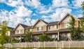 Nice neighborhood on a sunny day. Townhouses with nicely landscaped front yard and fence