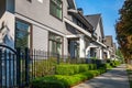 Nice neighborhood on a sunny summer day. Townhouses with nicely landscaped front yard and fence. Exterior Front Houses