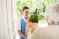 Nice nurse bringing vegetables to old patient Royalty Free Stock Photo