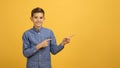 Nice Offer. Happy Smiling Teen Boy Pointing Aside At Copy Space Royalty Free Stock Photo