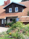 Beautiful wooden home and flowers, Lithuania Royalty Free Stock Photo