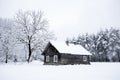 Nice old village house in the middle of beautiful winter with lots of white snow and trees. Royalty Free Stock Photo