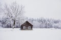 Nice old village house in the middle of beautiful winter with lots of white snow and trees.