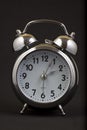 Nice old vintage chrome metal twin bell alarm clock on black background Royalty Free Stock Photo