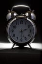 Nice old vintage chrome metal twin bell alarm clock on black background Royalty Free Stock Photo